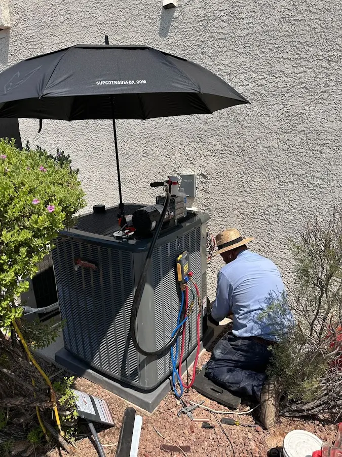 HVAC technician performing outdoor AC maintenance in Post Falls